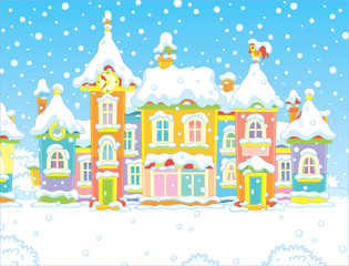 Colorful houses of a small toy town in a snowy winter day, vector illustration in a cartoon style