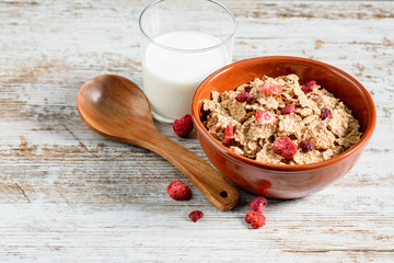 Toasted, sugar coated flakes of rice with milk on the white background.
