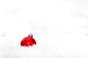 Red christmas balls on white snow on light background , New year and christmas backgrounds