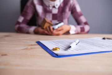 woman divorce documents ring house car