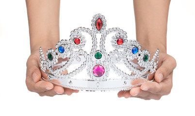 Hand holding Silver crown with jewels isolated on white background © cloud7days