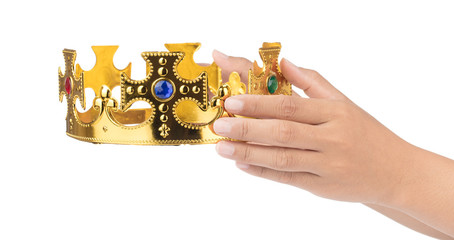 Hand holding crown golden isolated on a white background