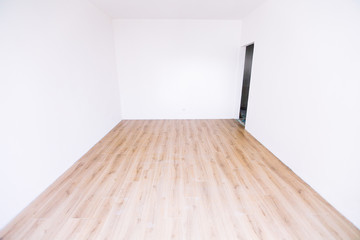 Photo of a white empty scandinavian room interior with wooden floor and walls.