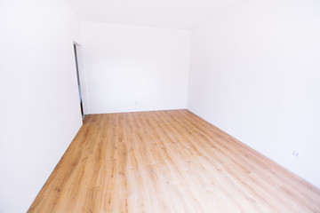 Fototapeta premium Photo of a white empty scandinavian room interior with wooden floor and walls.