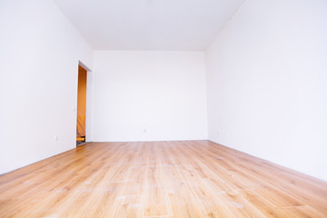 Photo of a white empty scandinavian room interior with wooden floor and walls.