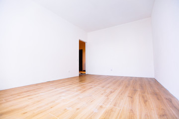 Photo of a white empty scandinavian room interior with wooden floor and walls.