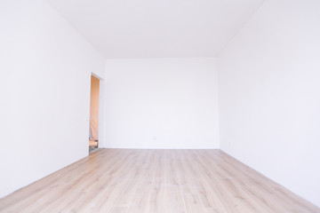 Photo of a white empty scandinavian room interior with wooden floor and walls.
