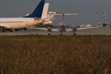 Fototapeta premium Airplanes in detail at sunset in the airport.