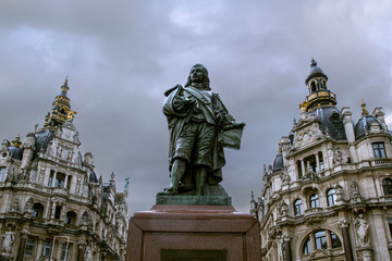 Fototapeta na wymiar Statue of the David Teniers the Younger in the city center of Antwerp, Belgium. Flemish painter(1610 -1690). The attraction of Antwerp . Cloudy day .