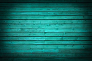 Horizontal wooden planks painted turquoise with vignette as background (spotlight)