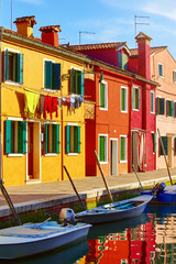 Fototapeta na wymiar Burano island in Venice Italy picturesque over canal with boats