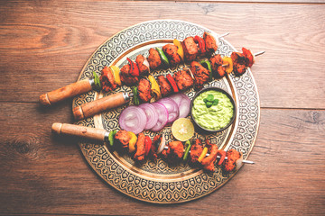 Chicken tikka /skew Kebab. Traditional Indian dish cooked on charcoal and flame, seasoned &...