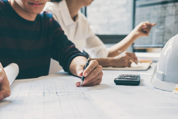 Fototapeta premium Team of Construction engineering or architect hands working on blueprint inspection in workplace, drawing and sketching meeting for architectural project working with partner