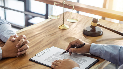 Law, lawyer attorney and justice concept, Consultation between a male lawyer and client, giving advice and prosecutions about the regarding real estate, report of the important case in the workplace