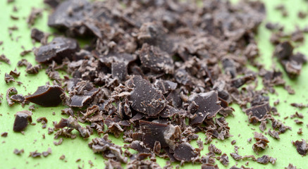 dark chocolate crumbs on green background,shallow dof