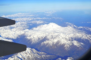 The view from the window of an airplane over the mountains of the Caucasus
