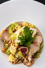Grilled chicken breast salad with figs, green apple, celery, nuts and Parmesan.