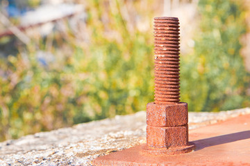Old rusty anchor bolt with iron plate - image with copy space