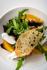 Salad with dried beetroot, apple, orange and soft goat cheese.
