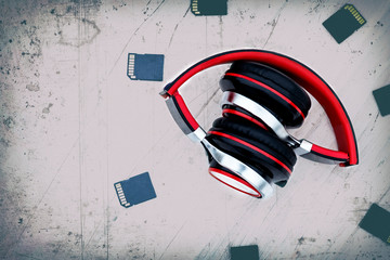 Wooden background in the old style. Musical accessories. headphones are red. memory card. have toning. space for text