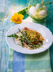 Easter meal. Veal cutlet with herb crust and risotto