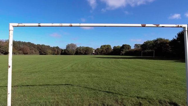 POV View of a Ball going through football / soccer goal posts