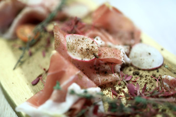 Parma ham on wooden plate