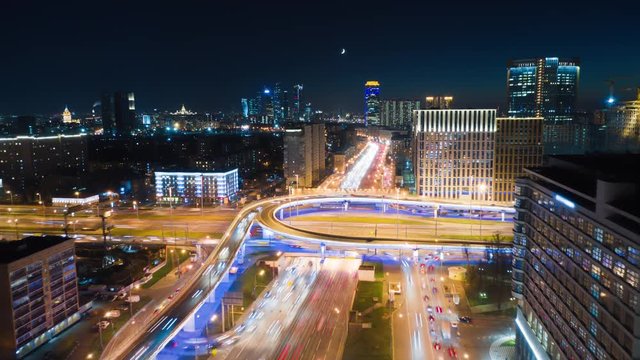 Amazing motion timelapse of busy Moscow highway on the night, view from above. Aerial shot of city center crossroads with a lot of traffic and glittering city lights. 8K ultra high definition footage.