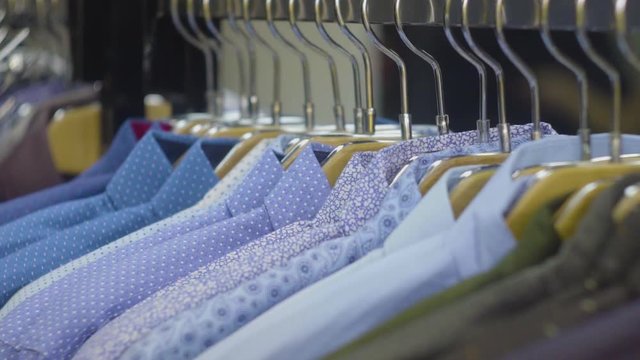 Men's shirts on hangers in wardrobe