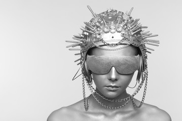 Futuristic woman in metal helmet and glasses