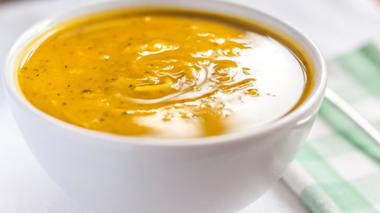 Close of white bowl with cabotia pumpkin soup