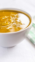 Close of white bowl with cabotia pumpkin soup