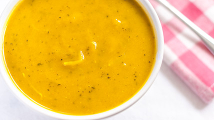 Close of white bowl with cabotia pumpkin soup