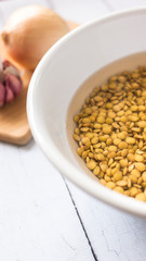Lentil bowl with water next to garlic