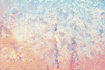 Frosty ice pattern on glass of window at sunny morning