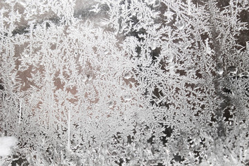 frosty natural pattern and sun on winter window