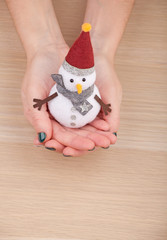 textile snowman woman hands wooden table studio 