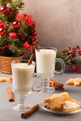 Christmas eggnog in glass mug and cinnamon.