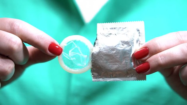 Girl unboxing condom. Safe sex concept