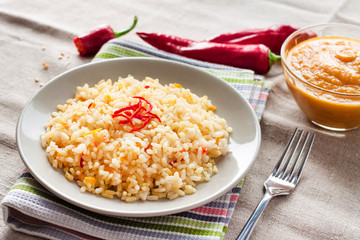 Spicy parboiled rice with carrots, yellow zucchini and chili peppers