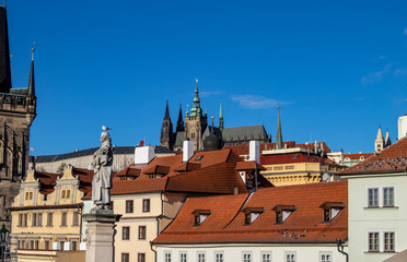 Fototapeta premium Prague, Czech Republic, Europe, panorama overlooking the historic buildings of Prague Castle, Charles Bridge and the Vltava River in front of interesting blue sky with clouds