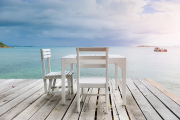 Fototapeta na wymiar White wooden table and chairs.