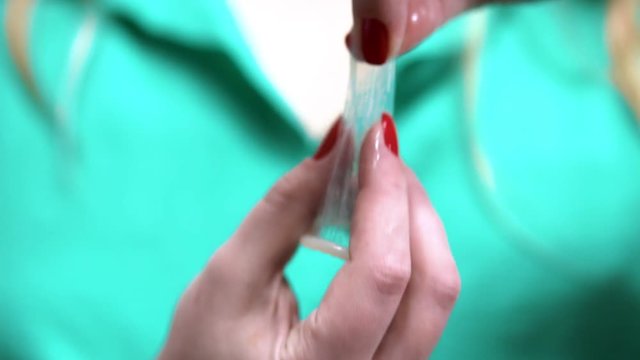 Safe sex concept. unboxing Condom in hand