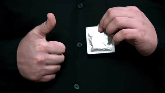 condom in hand men. Safe sex concept