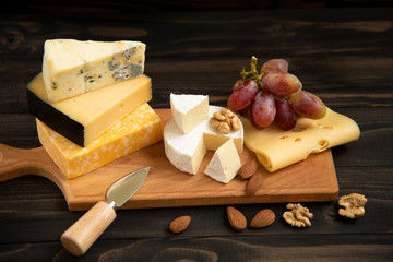 Various types of cheese on a rustic table