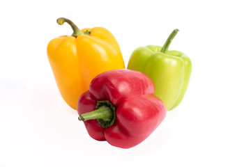Red and green sweet peppers on a white background...
