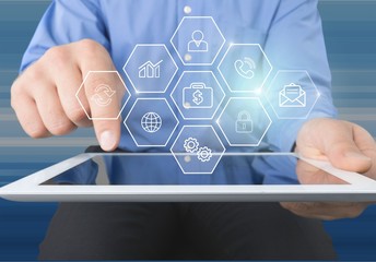 Male hands holding a tablet PC on background