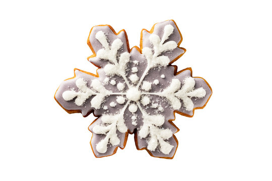 Closeup image of christmas silver gingerbread snowflake cookie with icing isolated at white background.