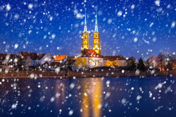 Old town of Wroclaw on a cold winter night with falling snow, Poland