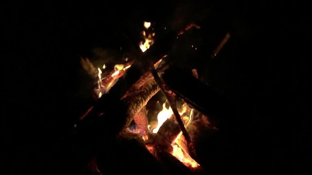 A campfire firing slowly with a sinister dark background